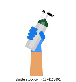 The oxygen tank held by hand of healthcare provider.