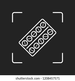 Pack Pills Icon. White object in camera autofocus on dark background