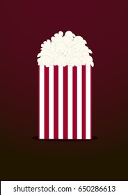 packet of popcorn on a dark red background.