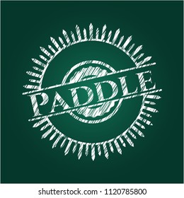 Paddle chalkboard emblem on black board