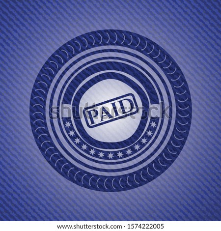 paid icon inside badge with denim texture