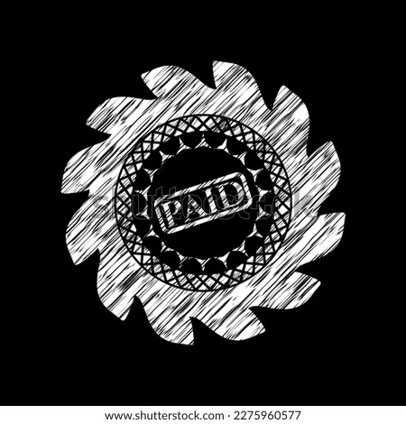 paid icon inside chalkboard emblem on black board. 