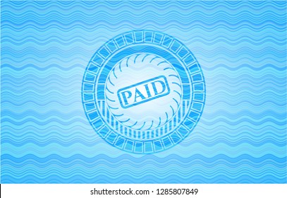 paid icon inside light blue water style emblem.