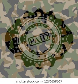 paid icon on camouflage pattern