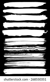 Paint brush strokes collection. Set of vector paint brush strokes. White design elements. EPS10 vector elements isolated on black.