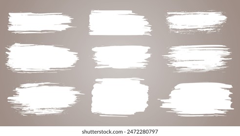 Paint brush. White ink grunge brush strokes. Vector paintbrush set. Grunge design elements. Painted ink stripes. Creative isolated spots. Ink smudge abstract shape stains and smear set