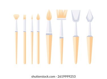 Paint brushes and palette knives forming a colorful set of tools for creating art
