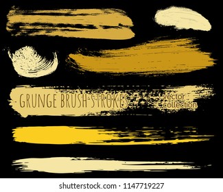 Paint lines grunge collection. Set of golden grungy hand drawn brush strokes isolated on black. Abstract ink texture, design elements, borders or frames. Brush strokes set backgrounds.