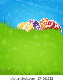 Painted Easter eggs on a green meadow