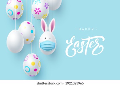 Painted Easter hanging eggs with rabbit ears and mask. Coronavirus, Covid-19 protection holiday concept. Handwritten lettering on blue background. Vector.