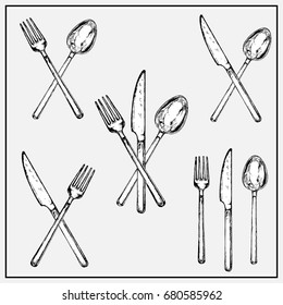 Painted sets of cutlery isolated on a light background.