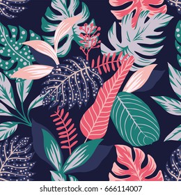 Painted tropical exotic leaves abstract colors in a cartoon style. Seamless vector wallpaper pattern on a dark blue background