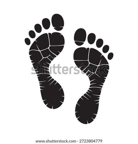 A pair of black footprints depicting human steps or imprints on a surface