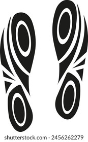 A pair of black shoes with a design on them. The design is a circle with a dot in the middle