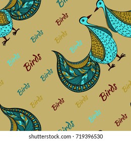 A pair of blue birds ornament from swirls on a background of words