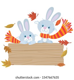 A pair of bunnies with scarf behind a wooden sign