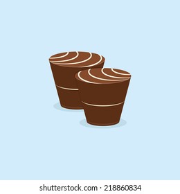 a pair of chocolates with white cream on a blue background