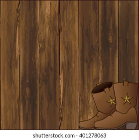 Pair of cowboy boots resting in front of weathered barn wall