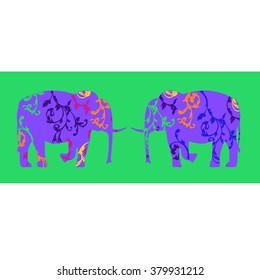A pair of elephants , decorated with floral ornaments