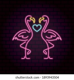 A pair of flamingos in love with a heart between them. Neon illustration. Happy Valentine's Day. Bright banner on a brick wall.