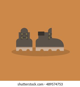 A pair of leather brown boots icon /  flat vector illustration