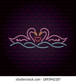 A pair of loving swans with a heart between them on the water. Neon illustration. Happy Valentine's Day. Bright banner on a brick wall.