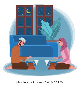 A pair of Muslim men and women are reciting the Qur'an in their home at night.