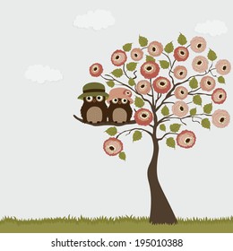 A pair of owls on the branch of a tree roses