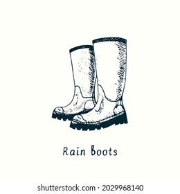 Pair of rain boots. Ink black and white doodle drawing in woodcut style.