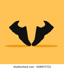 pair of shoes on orange background