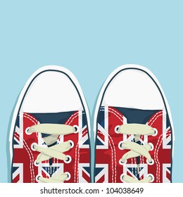 pair of shoes with union jack decoration on blue background, with space for text