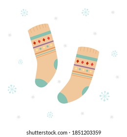 Pair of warm winter socks on snowflakes background