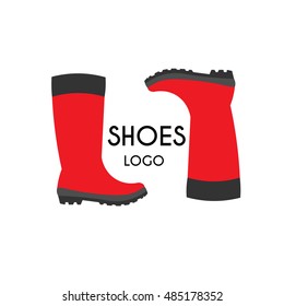 Pair of water resistant shoes, red rain boots logo on white