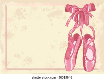 A pair of well-worn ballet pointes shoes on old paper background