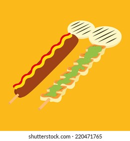 a pair of wooden sticks with fried food on a yellow background