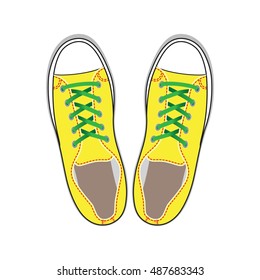 Pair of yellow gumshoes. Teenage school street wear. Top view sneakers.