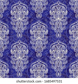 Patrón transparente de encaje paisley con un patrón secreto azul sobre fondo azul en vectores, tela india