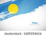 Palau flag made in brush stroke background. National day of Palau. Creative Palau national country flag icon. Abstract painted grunge style brush flag background.