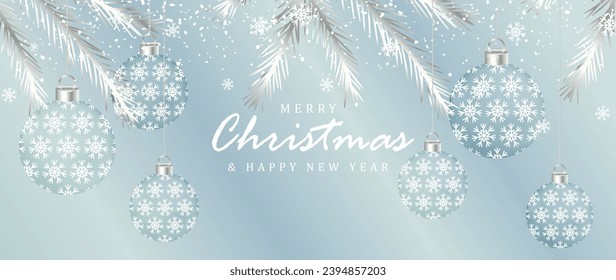 Pale blue New Year and Christmas winter card with silver fir branches, snow, snowflakes and transparent Christmas balls.