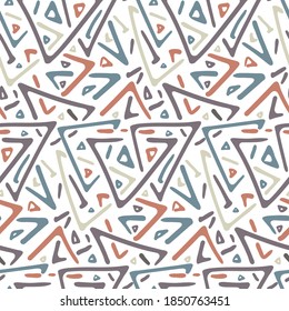 Pale colorful triangles tribal seamless pattern on peach color background. Trendy fashion vector geometric texture with hand drawn shapes for textile, wrapping paper, cover, surface, wallpaper
