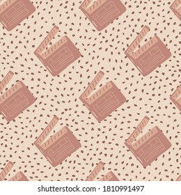 Pale seamless pattern with cinema clapperboard silhouettes. Dotted background. Dark pink palette. Decorative backdrop for wallpaper, textile, wrapping paper, fabric print. Vector illustration.