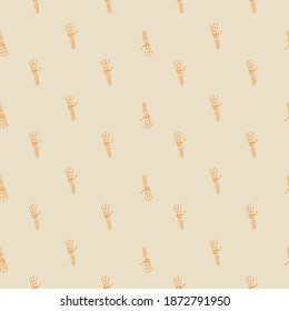Pale seamless pattern with doodle little skeleton bones hand. Orange ornament on grey background. Graphic design for wrapping paper and fabric textures. Vector Illustration.