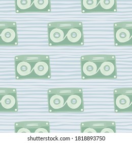 Pale stylized seamless cassette pattern. Light green music disco ornament on blue soft stripped background. Decorative backdrop for wallpaper, textile, wrapping, fabric print. Vector illustration.