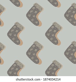 Pale tones seamless pattern with grey winter shoes ornament. Boots with snowflakes on pastel background. Stock illustration. Vector design for textile, fabric, giftwrap, wallpapers.