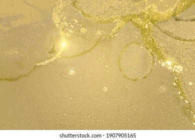 Pale yellow and gold marble texture with sparkles. Abstract vector background in alcohol ink technique. Modern paint with glitter. Template for banner, poster design. Fluid art painting
