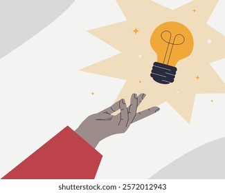 The palm of a hand reaching for a burning light bulb. A symbol of a new idea, innovation and creativity.