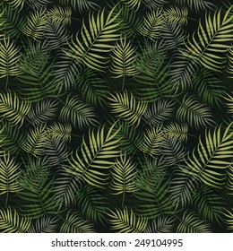 Palm leaves pattern on green background