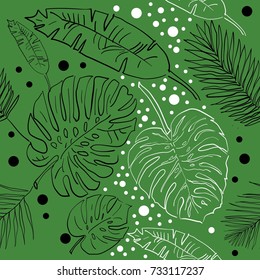 Palm leaves. Pattern on a green background