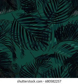 Palm leaves silhouette on the green background. Vector seamless pattern with tropical plants.