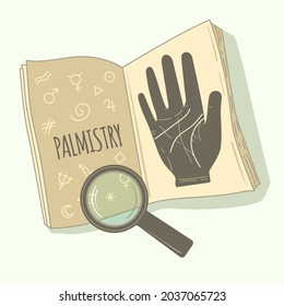 Palmistry. Textbook on palmistry and a magnifying glass.